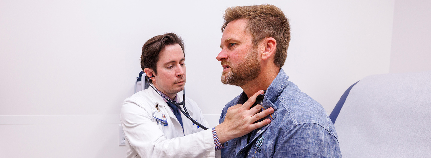 Dr. Bradley Deere, associate professor of cardiology, examines John Decker in a follow-up appointment.
